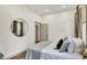 Calm bedroom with a mirror on the wall, hardwood floors, and a minimalist design at 1046 N Hamilton Ave, Indianapolis, IN 46201