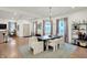Open-concept dining and living area with a modern chandelier, hardwood floors, and a fireplace at 1046 N Hamilton Ave, Indianapolis, IN 46201