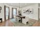 Dining room with a modern chandelier, white chairs, and abstract artwork on the walls at 1046 N Hamilton Ave, Indianapolis, IN 46201