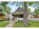 Charming home featuring a covered porch, brick accents, and a beautifully landscaped front yard at 1046 N Hamilton Ave, Indianapolis, IN 46201