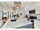 Bright kitchen with a marble island, stainless steel appliances, and modern pendant lighting at 1046 N Hamilton Ave, Indianapolis, IN 46201