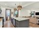 Kitchen with island seating, stainless steel appliances, and an open layout to the living area at 1046 N Hamilton Ave, Indianapolis, IN 46201
