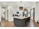 Modern kitchen with stainless steel appliances, island seating, and stylish pendant lighting at 1046 N Hamilton Ave, Indianapolis, IN 46201