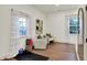 This living room features hardwood floors, natural light, and seating for two at 1046 N Hamilton Ave, Indianapolis, IN 46201