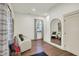 This room features hardwood floors, soft armchairs, a window, and a full length mirror at 1046 N Hamilton Ave, Indianapolis, IN 46201