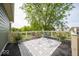 Stylish back deck with outdoor rug, potted plants, and white railing overlooking a lush green lawn and mature trees at 10865 Fairwoods Dr, Fishers, IN 46037