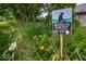 Backyard shows a certified wildlife habitat with native plants and flowers at 10865 Fairwoods Dr, Fishers, IN 46037