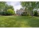Large, well-maintained backyard featuring mature trees and landscaping at 10865 Fairwoods Dr, Fishers, IN 46037