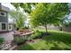 Beautiful backyard with lush lawn, paver patio and manicured garden beds at 10865 Fairwoods Dr, Fishers, IN 46037