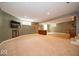Spacious finished basement with wet bar, built-ins, recessed lighting, and neutral carpeting at 10865 Fairwoods Dr, Fishers, IN 46037