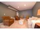 Cozy basement featuring comfortable seating, including armchairs and a sofa, ideal for relaxation at 10865 Fairwoods Dr, Fishers, IN 46037