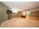 Spacious basement area with a large TV, wet bar, and ample room for entertainment or relaxation at 10865 Fairwoods Dr, Fishers, IN 46037