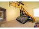 Stylish bedroom featuring unique built-in shelving and ladder access at 10865 Fairwoods Dr, Fishers, IN 46037