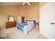Bright bedroom with neutral walls, plush carpet, classic dresser and a comfortable bed for a peaceful retreat at 10865 Fairwoods Dr, Fishers, IN 46037