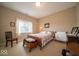 Inviting bedroom features a cozy bed, classic wooden furniture, natural light, and a peaceful, relaxing atmosphere at 10865 Fairwoods Dr, Fishers, IN 46037