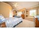 Comfortable bedroom featuring arched doorway, sunny windows, built-in shelves, and cozy window seat for relaxation at 10865 Fairwoods Dr, Fishers, IN 46037