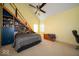 Modern bedroom featuring bold geometric bedding, built-in shelving and a vaulted ceiling with a unique design at 10865 Fairwoods Dr, Fishers, IN 46037