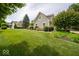 Well-maintained green home with an expansive lawn, mature trees, and inviting curb appeal at 10865 Fairwoods Dr, Fishers, IN 46037