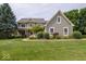 Charming two-story home boasts a lush lawn, mature trees, and inviting curb appeal at 10865 Fairwoods Dr, Fishers, IN 46037