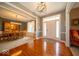 Elegant foyer featuring hardwood floors, a chandelier, and a view into the formal dining area at 10865 Fairwoods Dr, Fishers, IN 46037