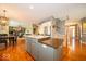 Open concept kitchen with center island, granite countertops, and hardwood floors at 10865 Fairwoods Dr, Fishers, IN 46037