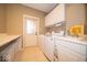Well-equipped laundry room with modern washer and dryer, ample counter space, and storage cabinets at 10865 Fairwoods Dr, Fishers, IN 46037