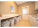 Functional laundry room with washer, dryer, folding counter, and storage bins for efficient organization at 10865 Fairwoods Dr, Fishers, IN 46037