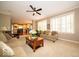 Comfortable living room showcasing neutral tones, plush seating, and a ceiling fan for a cozy atmosphere at 10865 Fairwoods Dr, Fishers, IN 46037