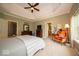 Comfortable main bedroom featuring a tray ceiling, large window, and neutral carpeting at 10865 Fairwoods Dr, Fishers, IN 46037