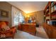 Traditional office with a large wooden desk, built-in bookshelves, and natural light at 10865 Fairwoods Dr, Fishers, IN 46037
