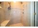 Contemporary shower with tiled walls, built-in bench, and dual shower heads at 10865 Fairwoods Dr, Fishers, IN 46037