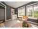 Sun-drenched sunroom with a built-in cabinet and charming wicker chair at 10865 Fairwoods Dr, Fishers, IN 46037