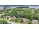Aerial view of homes surrounded by mature trees, professionally landscaped neighborhood, lake in background at 11266 Old Stone Dr, Indianapolis, IN 46236