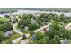 Aerial view of lakefront homes surrounded by mature trees, professionally landscaped neighborhood at 11266 Old Stone Dr, Indianapolis, IN 46236