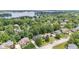 Aerial view of homes surrounded by mature trees, professionally landscaped neighborhood, lake in background at 11266 Old Stone Dr, Indianapolis, IN 46236