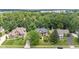 Aerial view of home surrounded by mature trees, professionally landscaped with lake in background at 11266 Old Stone Dr, Indianapolis, IN 46236