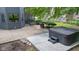 Outdoor patio space with a hot tub and grill, complemented by manicured landscaping at 11266 Old Stone Dr, Indianapolis, IN 46236