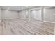 Spacious basement with wood-look flooring and ample lighting, ready to be customized for your needs at 11266 Old Stone Dr, Indianapolis, IN 46236
