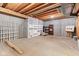 Unfinished basement offering ample storage space, exposed ceiling beams, and a concrete floor at 11266 Old Stone Dr, Indianapolis, IN 46236