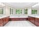 Luxurious bathroom with a large soaking tub surrounded by windows at 11266 Old Stone Dr, Indianapolis, IN 46236