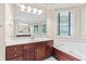 Elegant bathroom featuring dual vanities, a soaking tub, and bright lighting at 11266 Old Stone Dr, Indianapolis, IN 46236