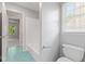 Well-lit bathroom showcasing a toilet, tub, and a peek through to the sun-drenched hallway at 11266 Old Stone Dr, Indianapolis, IN 46236