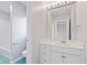 Well-lit bathroom showcasing a vanity with a sink and tiled floor, plus open doorway to tub at 11266 Old Stone Dr, Indianapolis, IN 46236
