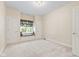 Bright bedroom featuring neutral carpet, a large window seat, and fresh neutral paint at 11266 Old Stone Dr, Indianapolis, IN 46236