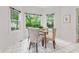 Bright breakfast nook featuring a glass table and upholstered chairs with a view of lush greenery at 11266 Old Stone Dr, Indianapolis, IN 46236
