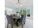 Bright dining room with a view to the backyard and a stylish chandelier above the dining table at 11266 Old Stone Dr, Indianapolis, IN 46236