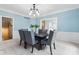 Well-lit dining room with an open doorway and a large window offering a picturesque view of the outdoors at 11266 Old Stone Dr, Indianapolis, IN 46236