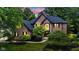 Stunning brick two-story home with a meticulously landscaped lawn and a beautiful arched entryway at 11266 Old Stone Dr, Indianapolis, IN 46236