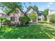 Charming two-story brick house with well-maintained lawn and lush landscaping at 11266 Old Stone Dr, Indianapolis, IN 46236