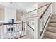 Open-concept foyer with staircase offering a glimpse of the living room below and an airy atmosphere at 11266 Old Stone Dr, Indianapolis, IN 46236
